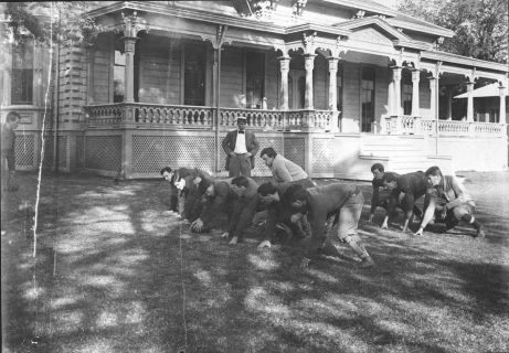 Early College of Hawaiʻi football team practices outside the Maerten House, home of the College of Hawaiʻi, 1908 - 1912 (University Archives Photograph)